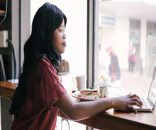 Woman using a computer at a cafe in South Sudan